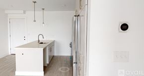 Boston apartment for rent - A white kitchen with a sink and a refrigerator.