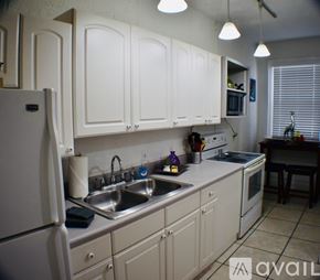 Tampa apartment for rent - A kitchen with white cabinets and a sink.
