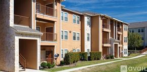 New Braunfels apartment for rent - A row of apartment buildings with balconies and satellite dishes on the roofs.