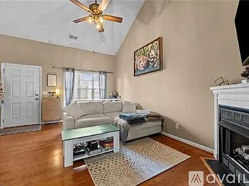 Fall River apartment for rent - A living room with a white couch and a painting on the wall.