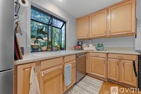 Bainbridge Island apartment for rent - A kitchen with wooden cabinets and a stainless steel refrigerator.