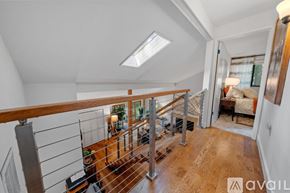 Bainbridge Island apartment for rent - A well-lit, spacious room with a skylight and a wooden staircase leading to the upper floor.