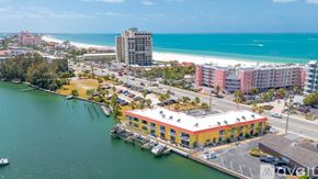 St. Pete Beach apartment for rent - A beachfront area with a pier and buildings.