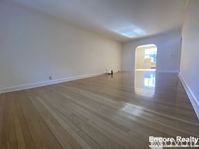Brookline apartment for rent - A room with wooden flooring and white walls.