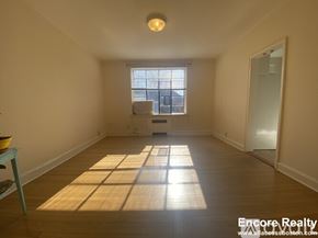 Brookline apartment for rent - A sunny room with a window and a table with a bowl on it.