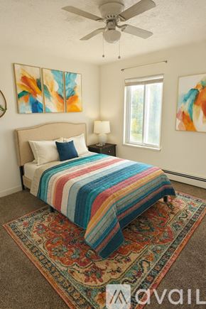 Monroe apartment for rent - A kitchen with white cabinets and a red rug on the floor.