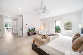 La Quinta house for rent - A bedroom with a large bed and a television in the corner.