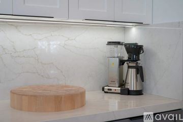 La Quinta house for rent - A kitchen counter with a coffee maker and a wooden chopping board.