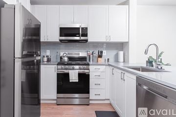 Tysons apartment for rent - A modern kitchen with a stainless steel refrigerator and oven.