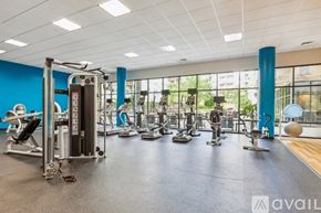 Tysons apartment for rent - A gym with a variety of equipment including treadmills, weights, and exercise machines.