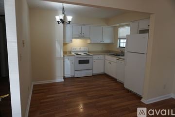Wetumpka apartment for rent - A kitchen with white appliances and wooden floors.