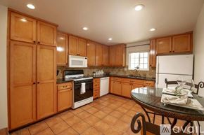 Los Angeles condo for rent - A kitchen with wooden cabinets and a tiled floor.