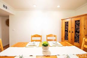 Los Angeles condo for rent - A dining room with a wooden table and chairs.