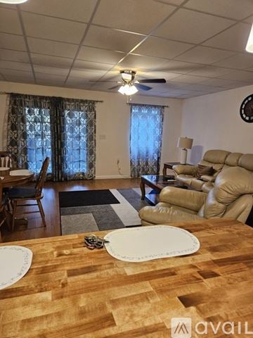 Oak Ridge apartment for rent - A living room with a brown wooden table in the foreground and a beige sofa in the background.