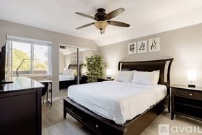 San Diego condo for rent - A bedroom with a large bed and a ceiling fan.