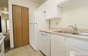 St. Cloud apartment for rent - A kitchen with white appliances and a wooden door.
