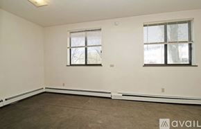 St. Cloud apartment for rent - A room with two windows and a carpeted floor.