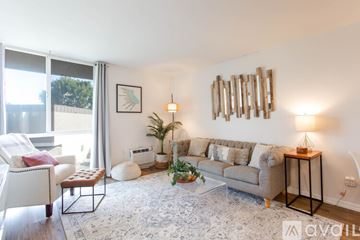 San Diego condo for rent - A living room with a couch, chair, and a table with a lamp on it.