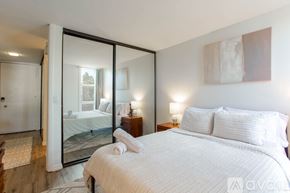 San Diego condo for rent - A bedroom with a large bed and a mirrored wall.