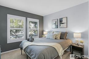 San Diego condo for rent - A bedroom with a large bed and two framed pictures on the wall.