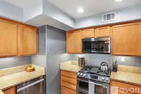 San Diego condo for rent - A kitchen with wooden cabinets and a stainless steel oven.