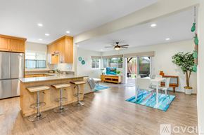 San Diego house for rent - A kitchen with a bar and a dining table.