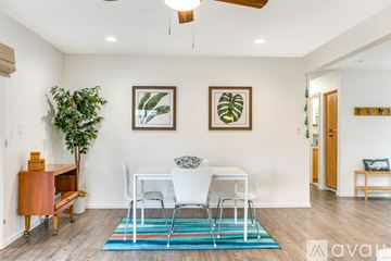 San Diego house for rent - A living room with a white chair and a blue rug.