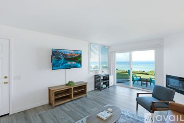 Imperial Beach condo for rent - A living room with a wooden bench and a painting on the wall.