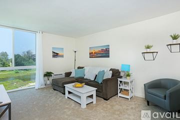 San Diego condo for rent - A living room with a couch, chair, and a table with a bowl of fruit on it.