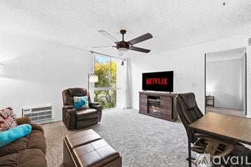 San Diego apartment for rent - A living room with a brown couch and a wooden cabinet.