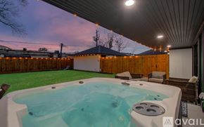 Houston house for rent - A hot tub is in the middle of a backyard.