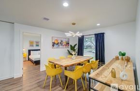 Houston house for rent - A dining room with a wooden table and yellow chairs.