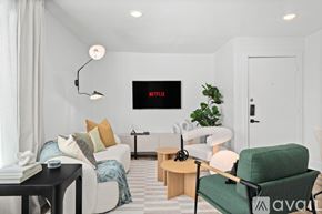 Dallas apartment for rent - A living room with a green armchair and a white sofa.