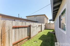 Imperial Beach house for rent - A backyard with a wooden fence and green grass.