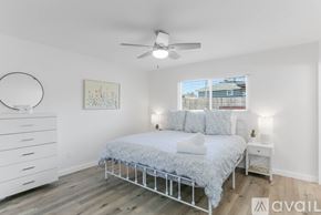 Imperial Beach house for rent - A bedroom with a bed, nightstand, and a painting on the wall.
