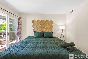San Diego condo for rent - A bedroom with a large bed and a decorative wall piece.