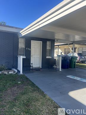Tampa apartment for rent - A house with a white door and a covered patio.