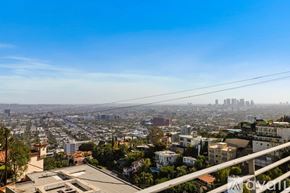 West Hollywood apartment for rent - A pool in a patio area with chairs and a table.
