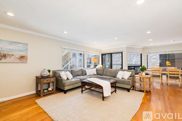 San Diego condo for rent - A living room with a large couch and a painting on the wall.
