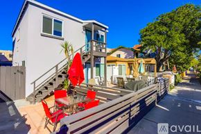San Diego apartment for rent - A modern house with a balcony and a glass table with chairs.