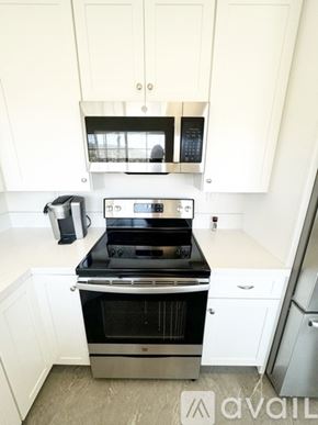 San Marcos condo for rent - A modern kitchen with white cabinets and stainless steel appliances.