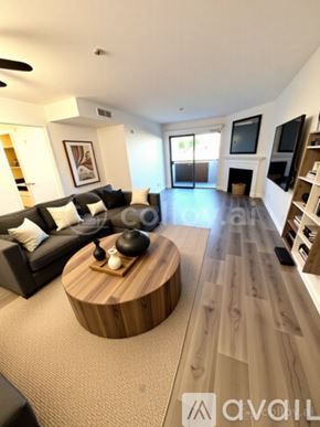 Los Angeles apartment for rent - A bedroom with a large bed and a bench with a red blanket on it.