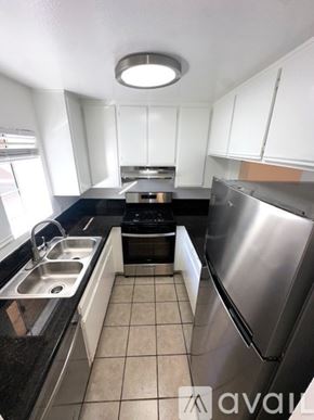Los Angeles apartment for rent - A kitchen with black countertops and white cabinets.