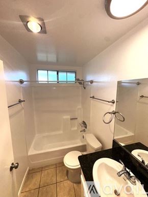 Los Angeles apartment for rent - A spacious living room with a fireplace and a kitchen area in the background.