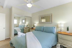 Imperial Beach condo for rent - A bedroom with a large bed and a mirror on the wall.