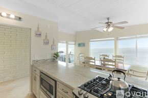 Imperial Beach condo for rent - A kitchen with a stove top oven and a fan.