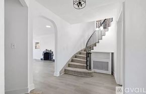 Detroit house for rent - A staircase with a metal railing leads up to a second floor.