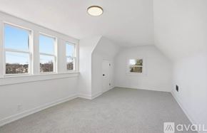 Detroit house for rent - A spacious room with a window and a door.