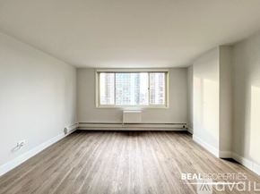 Chicago apartment for rent - A spacious room with wooden floors and large windows is available for rent.