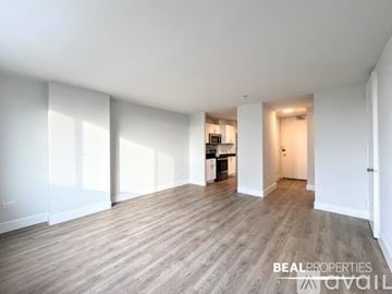 Chicago apartment for rent - A spacious kitchen with white cabinets and a refrigerator is visible in the image.